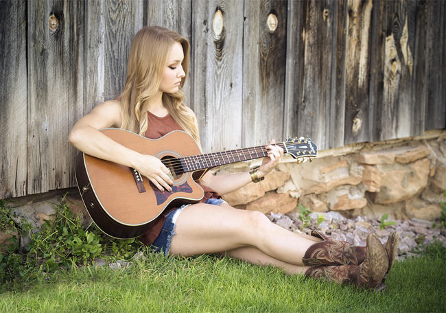 sweet girl with music guitar in open